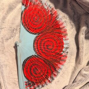 Handheld Folding Fan with Red Spiral Design
